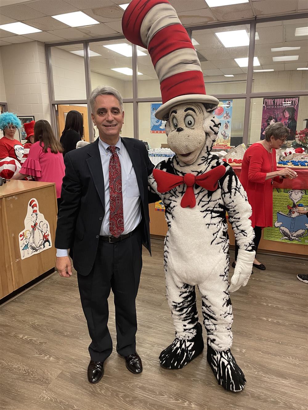 AIDB President, Dr. John Mascia taking a photo with the Cat. Always expect Dr. Mascia  to attend the Read Across America event hosted at ASB Library. 